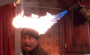 Robber Harry Lime (Joe Pesci) has his head set on fire by one of the traps